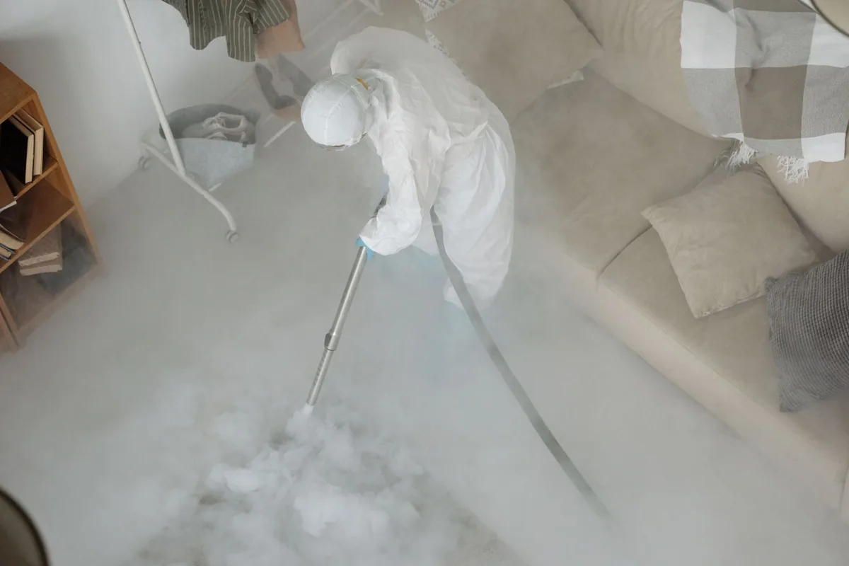 Biohazard cleanup technician in protective equipment, Glenwood, AR